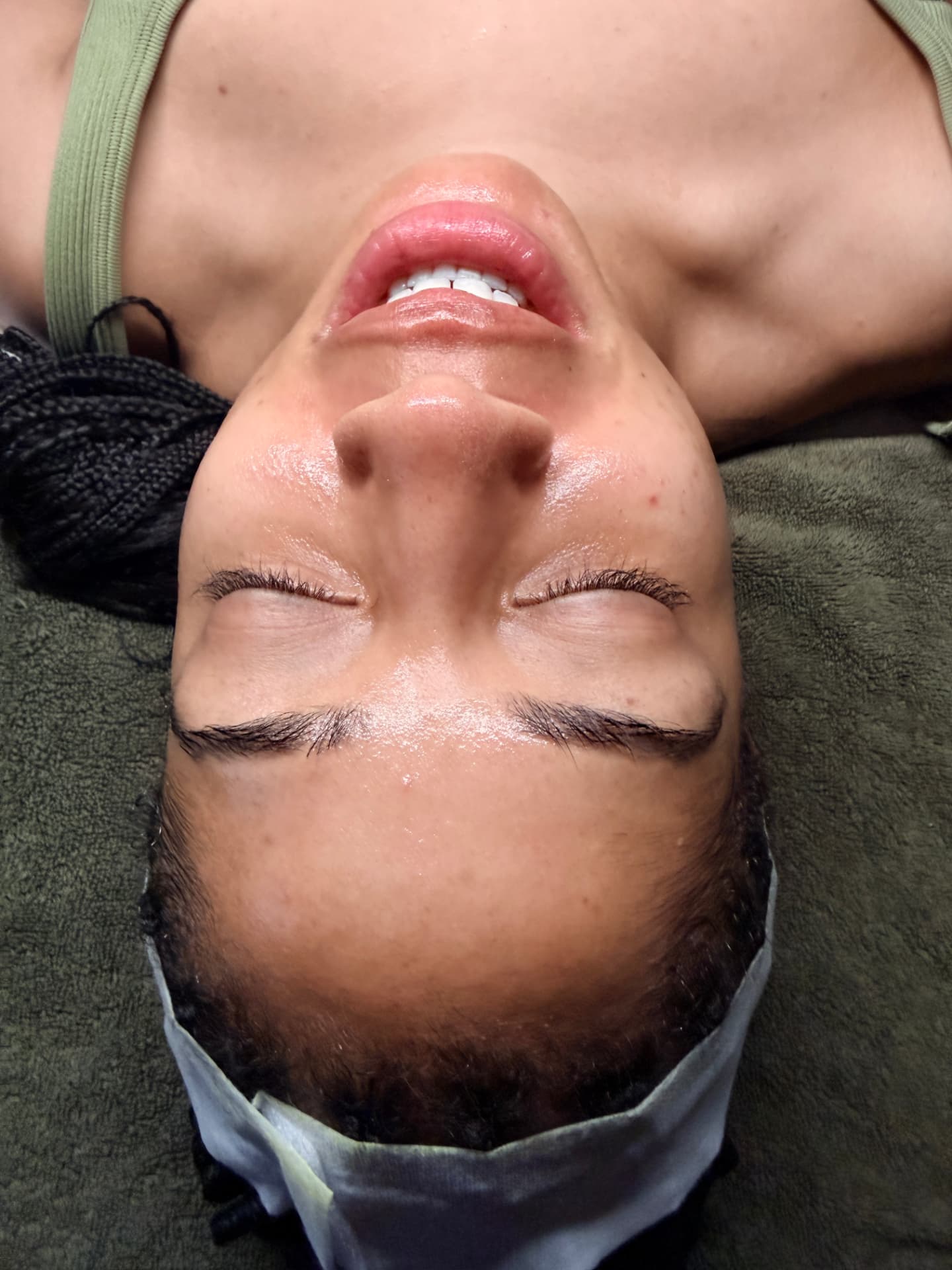 Client smiling after a glow facial with radiant, even skin